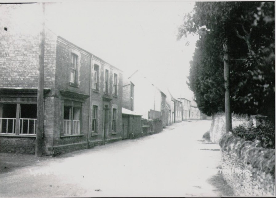 Northampton Road, Lavendon, on a busy day with the former butcher's shop on the left.